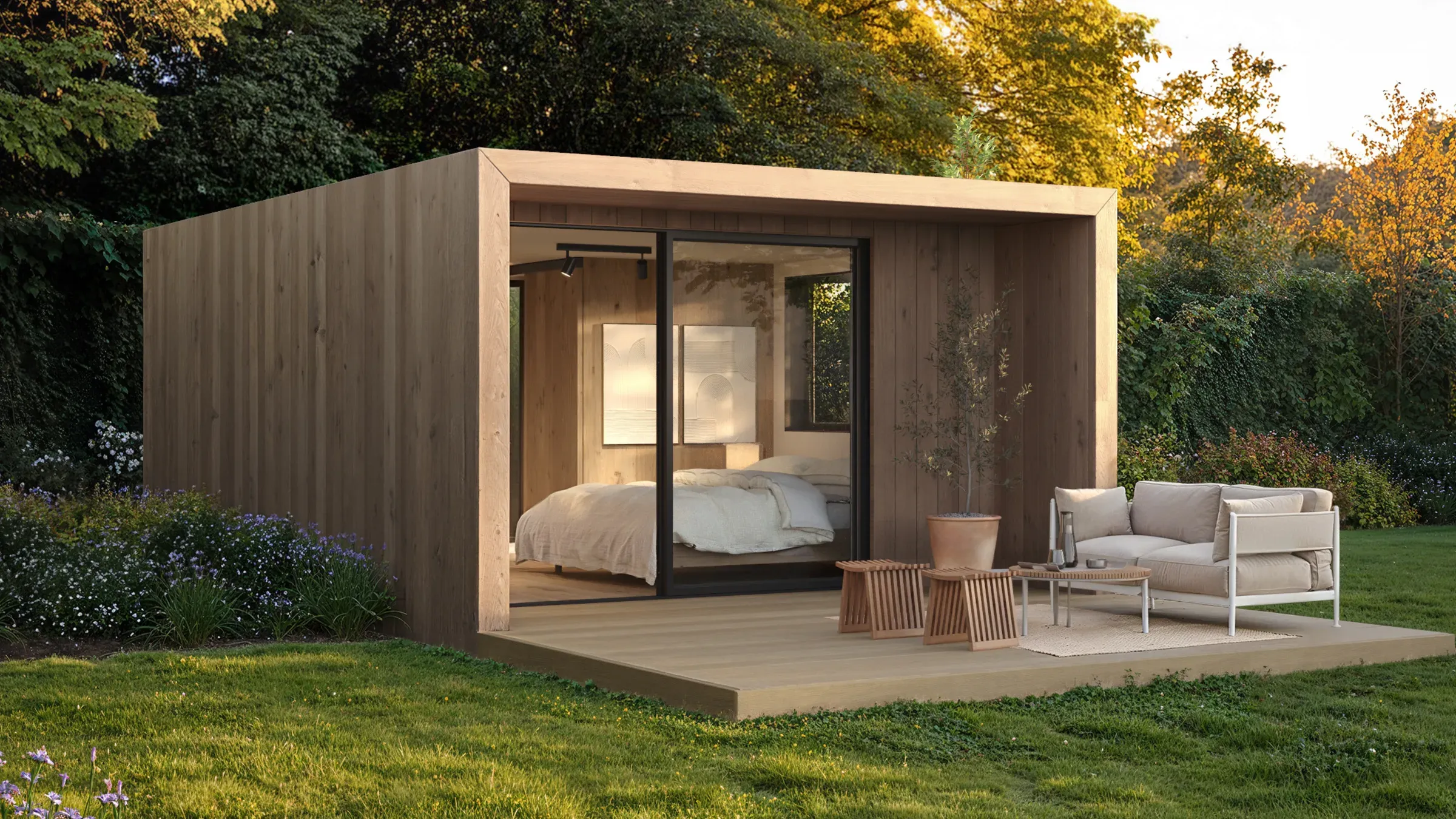 Suite NOOK acabada en fábrica, iluminada al anochecer sobre terreno abierto — cabaña modular de hostelería con ancho legal. Visualización.